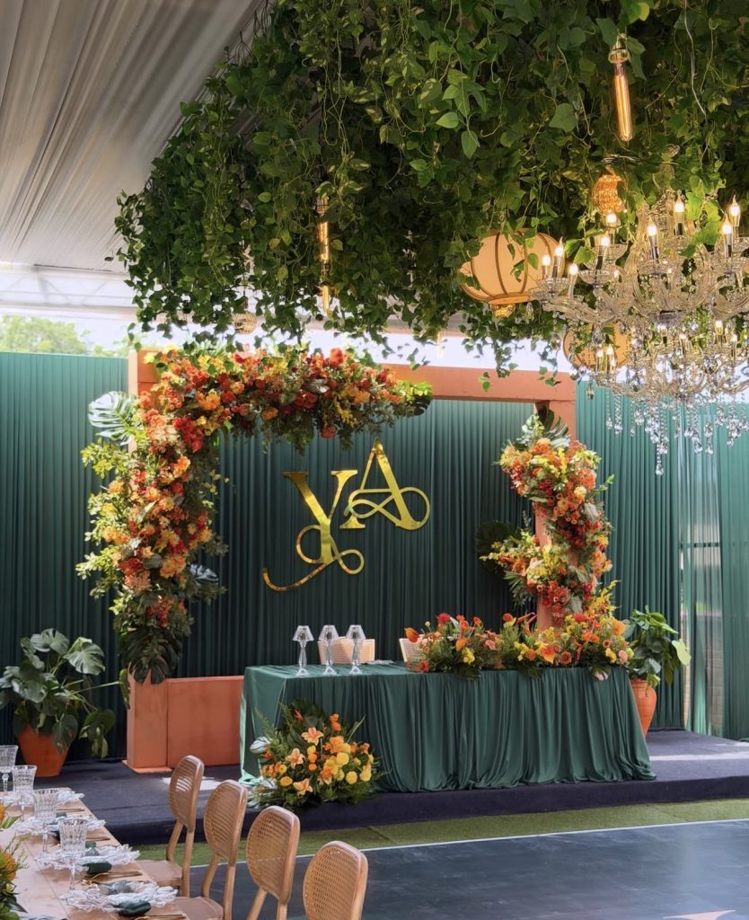 Green and gold traditional wedding stage with orange florals by Fems Events