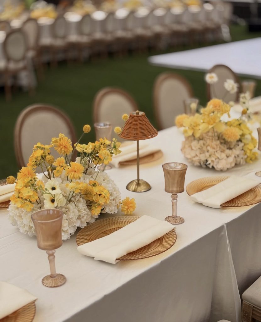 Yellow floral tablescape with gold glassware for a traditional wedding by Fems Events