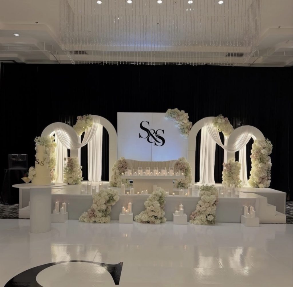 White and gold arched wedding stage backdrop by Fems Events