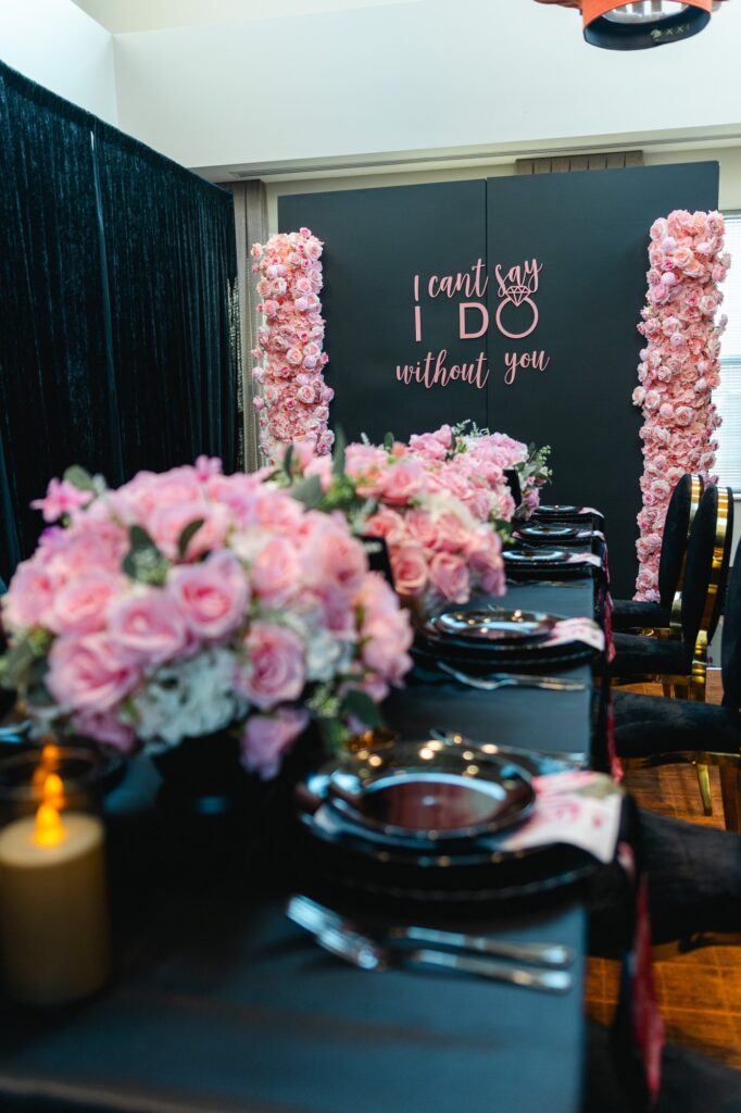 Black and pink bridal shower backdrop with rose pillars by Fems Events