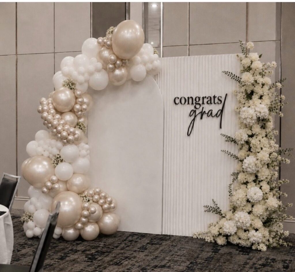 Congrats Grad balloon and floral backdrop by Fems Events